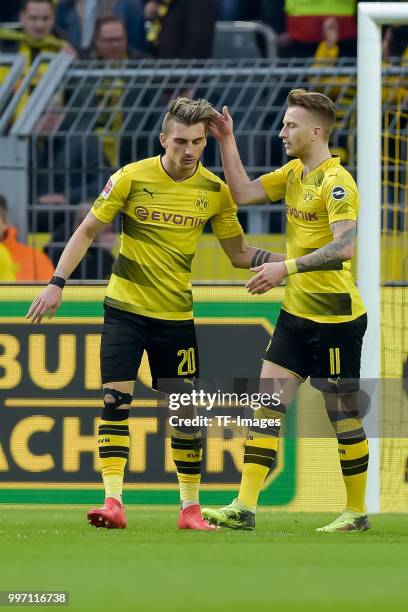 Maximilian Philipp of Dortmund and Marco Reus of Dortmund gesture during the Bundesliga match between Borussia Dortmund and Eintracht Frankfurt at...