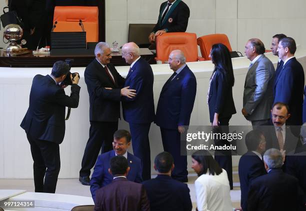 Former Turkish Grand National Assembly Speaker Ismail Kahrama greets AK Party's Izmir Deputy Binali Yildirim after he was elected as the new Turkish...