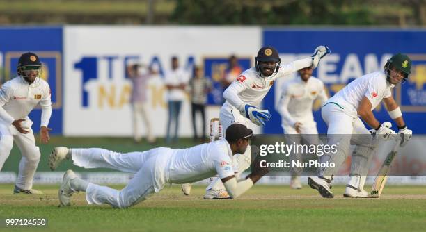 South African cricketer Aiden Markram and Sri Lankan wicket keeper Niroshan Dickwella look on as Sri Lankan cricketer Angelo Mathews takes a diving...