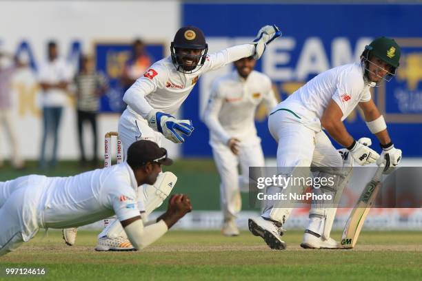 South African cricketer Aiden Markram and Sri Lankan wicket keeper Niroshan Dickwella look on as Sri Lankan cricketer Angelo Mathews takes a diving...