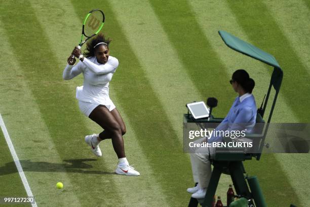 Player Serena Williams returns against Germany's Julia Goerges during their women's singles semi-final match on the tenth day of the 2018 Wimbledon...