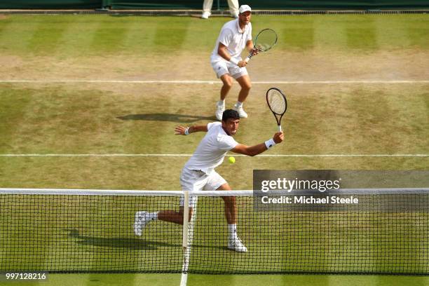 Dominic Inglot of Great Britain and Franko Skugor of Croatia return against Mike Bryan and Jack Sock of The United States during their Men's Doubles...