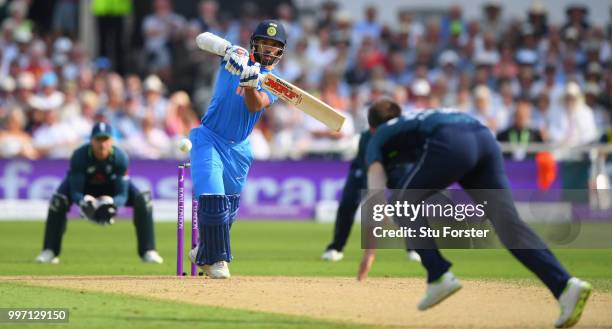 England bowler Mark Wood is hit for four runs by India batsman Shikhar Dhawan during the 1st Royal London One Day International match between England...