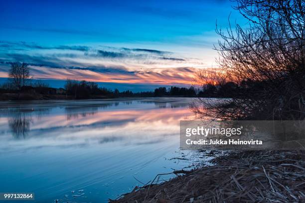 beautiful sunset by the river - heinovirta stockfoto's en -beelden