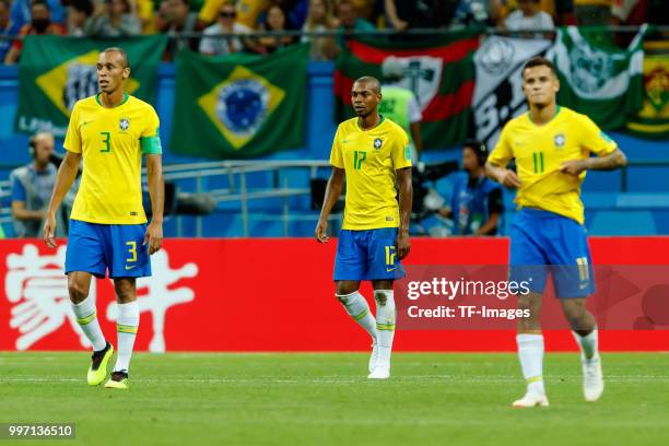 Miranda of Brazil, Fernandinho of Brazil and Phlippe Coutinho of Brazil look dejected during the 2018 FIFA World Cup Russia Quarter Final match...