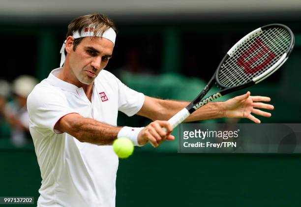 Roger Federer of Switzerland in action against Adrian Mannarino of France in the fourth round of the gentlemen's singles at the All England Lawn...