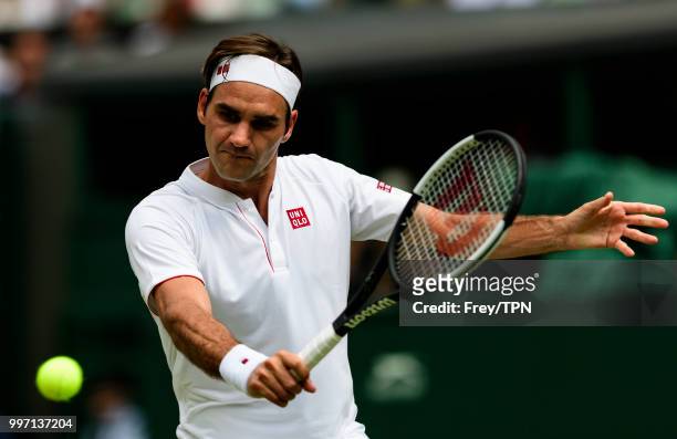 Roger Federer of Switzerland in action against Adrian Mannarino of France in the fourth round of the gentlemen's singles at the All England Lawn...