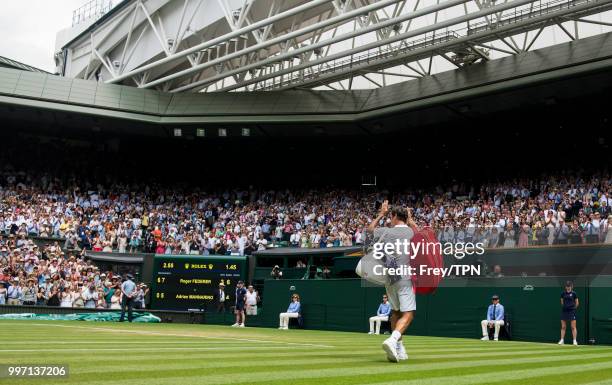 Roger Federer of Switzerland leaves court after beating Adrian Mannarino of France in the fourth round of the gentlemen's singles at the All England...