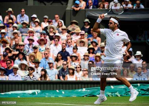 Roger Federer of Switzerland in action against Adrian Mannarino of France in the fourth round of the gentlemen's singles at the All England Lawn...