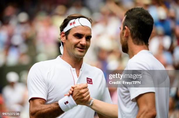 Roger Federer of Switzerland shakes hands with Adrian Mannarino of France after beating him in the fourth round of the gentlemen's singles at the All...
