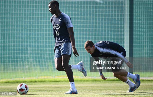 France's midfielder Paul Pogba jokes with France's forward Antoine Griezmann during a training session at the Glebovets stadium in Istra, some 70 km...