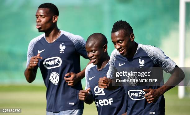 France's midfielder Paul Pogba, France's midfielder N'Golo Kante and France's midfielder Blaise Matuidi attend in training session at the Glebovets...