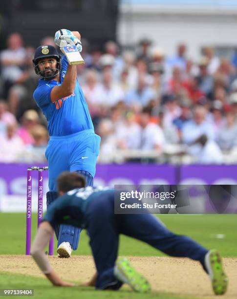 England bowler Mark Wood is hit for six runs by India batsman Rohit Sharma during the 1st Royal London One Day International match between England...