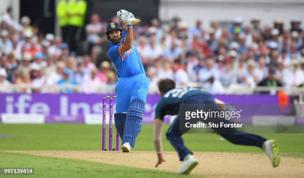 England bowler Mark Wood is hit for six runs by India batsman Rohit Sharma during the 1st Royal London One Day International match between England...
