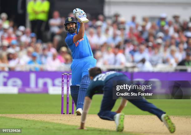 England bowler Mark Wood is hit for six runs by India batsman Rohit Sharma during the 1st Royal London One Day International match between England...