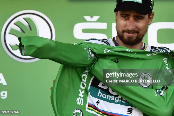 Slovakia's Peter Sagan puts on the best sprinter's green jersey on the podium after the sixth stage of the 105th edition of the Tour de France...