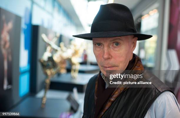 Plastinator Gunther von Hagens standing in front of a gold-plated plastinated figure in the Menschen Museum during a press conference on the museum's...