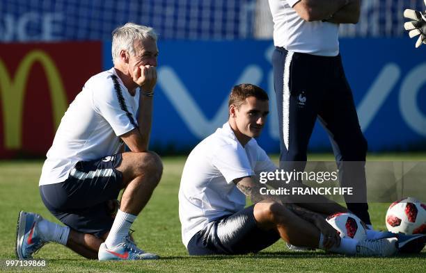 France's head coach Didier Deschamps and France's forward Antoine Griezmann look on during a training session at the Glebovets stadium in Istra, some...