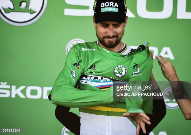 Slovakia's Peter Sagan puts on the best sprinter's green jersey on the podium after the sixth stage of the 105th edition of the Tour de France...