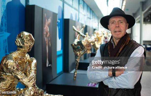 Plastinator Gunther von Hagens standing in front of a gold-plated plastinated figure in the Menschen Museum during a press conference on the museum's...