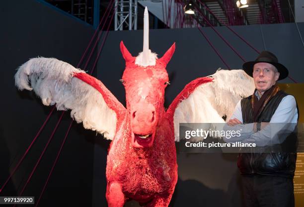 Plastinator Gunther von Hagens standing in front of a plastinated figure of a unicorn in the Menschen Museum during a press conference on the...