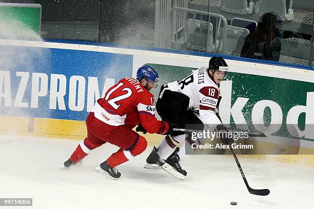 Kaspars Saulietis of Latvia is challenged by Jiri Novotny during the IIHF World Championship group F qualification round match between Czech Republic...