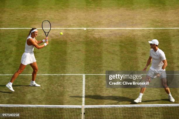 Jamie Murray of Great Britain and Victoria Azarenka of Belarus return against Jean-Julien Rojer and Demi Schuurs of The Netherlands during their...