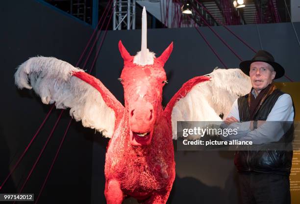 Dpatop - Plastination expert Gunther von Hagens stands next to a figure of a plastinated horse, exhibited in the form of a unicorn, at the Menschen...