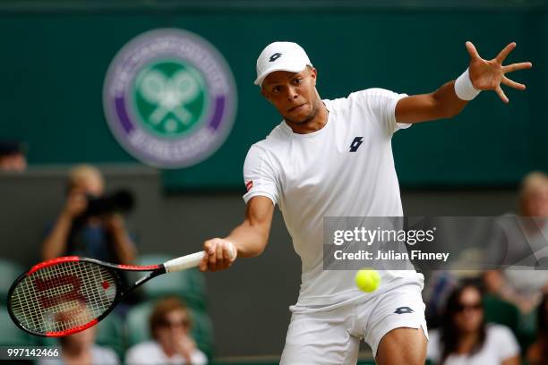 Jay Clarke of Great Britain returns against Juan Sebastian Cabal of Colombia and Abigail Spears of the United States during his Mixed Doubles...