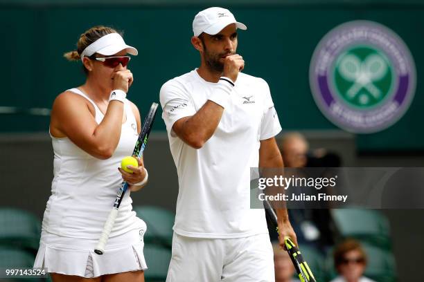 Juan Sebastian Cabal of Colombia and Abigail Spears of the United States discuss tactics during their Mixed Doubles quarter-final against Jay Clarke...