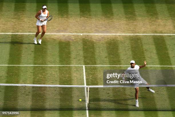 Juan Sebastian Cabal of Colombia and Abigail Spears of the United States return against Jay Clarke and Harriet Dart of Great Britain during their...