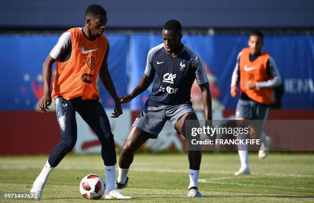 France's forward Ousmane Dembele vies with France's defender Benjamin Mendy during a training session at the Glebovets stadium in Istra, some 70 km...