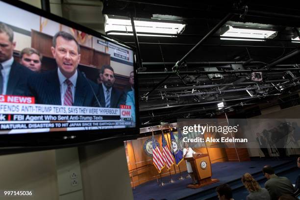 Television displays a House Oversight Committee hearing with FBI Agent Peter Strzok as House Minority Leader Nancy Pelosi speaks with reporters...