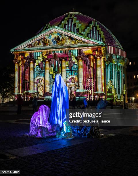 The art installation "Die Waechter der Zeit" by light artist Manfred Kielnhofer pictured outside St. Hedwig's Cathedral during the Festival of Lights...