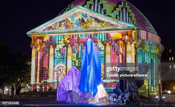 The art installation "Die Waechter der Zeit" by light artist Manfred Kielnhofer pictured outside St. Hedwig's Cathedral during the Festival of Lights...