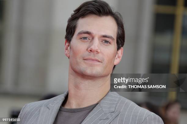 British actor Henry Cavill poses on the red carpet as he arrives to attend the world premiere of his new film Mission: Impossible Fallout, on July...
