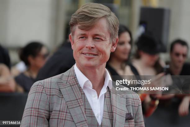 Danish actor Caspar Phillipson poses on the red carpet as he arrives to attend the world premiere of his new film Mission: Impossible Fallout, on...