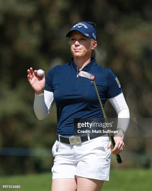 Morgan Pressel waves to the gallery after making a putt on the third hole during the first round of the Marathon Classic Presented By Owens Corning...