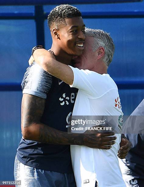 France's head coach Didier Deschamps jokes with France's defender Presnel Kimpembe during a training session at the Glebovets stadium in Istra, some...