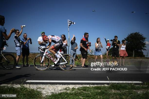 Spectators cheer as Latvia's Toms Skujins, wearing the best climber's polka dot jersey, pedals following his first ascend of the Mur-de-Bretagne hill...
