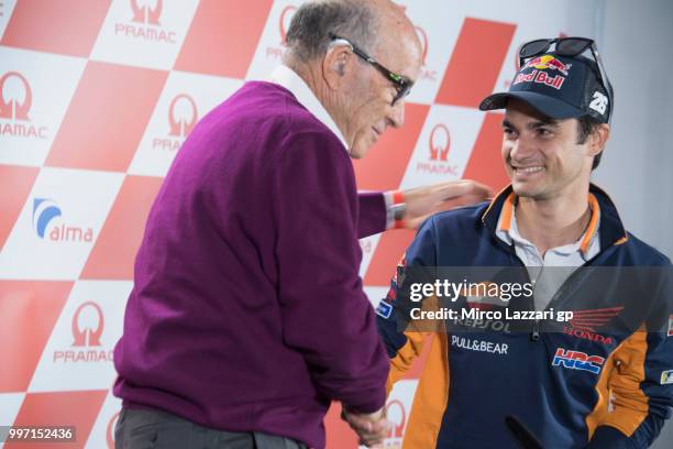 Dani Pedrosa of Spain and Repsol Honda Team hugs Carmelo Ezpeleta of Spain and Dorna CEO during the press conference in order to announce his retired...