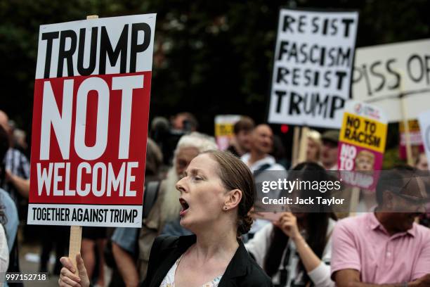 Protesters chant and wave placards during a demonstration outside Winfield House, the London residence of US ambassador Woody Johnson, where US...