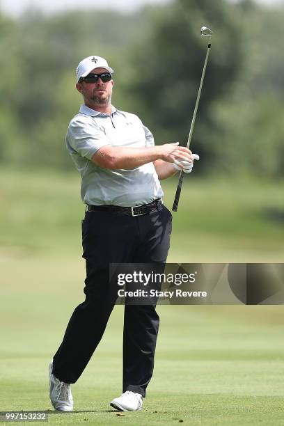 Steve Wheatcroft hits his approach shot on the 18th hole during the first round of the John Deere Classic at TPC Deere Run on July 12, 2018 in...