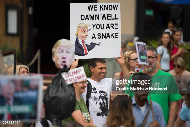 Anti Donald Trump signs are seen as protestors gather outside Cardiff Library on the Hayes in Cardiff to protest against a visit by the President of...