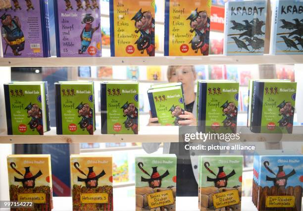 Katrin Menke setting books by Michael Ende on a bookshelf at the stand of the Thienemann-Esslinger Publishing House ahead of the Frankfurt Book Fair...