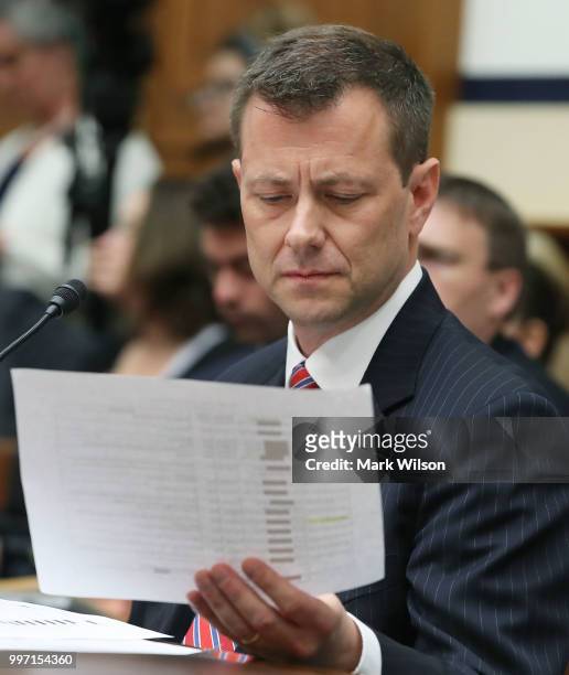 Deputy Assistant FBI Director Peter Strzok looks at a paper handed to him during a joint committee hearing of the House Judiciary and Oversight and...