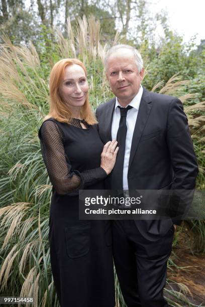 Actors Axel Milberg and Andrea Sawatzki standing on set during filming of the ZDF television movie "Ihr seid natürlich eingeladen" in...