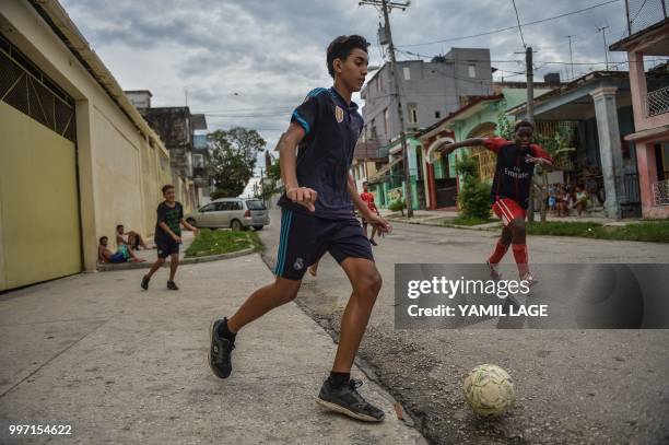 Cuban boys play football on a street in Havana, on July 12 three days ahead of the FIFA World Cup final match between France and Croatia in Russia.