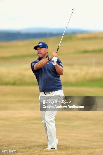 Lee Westwood of England takes his second shot on hole eighteen during day one of the Aberdeen Standard Investments Scottish Open at Gullane Golf...