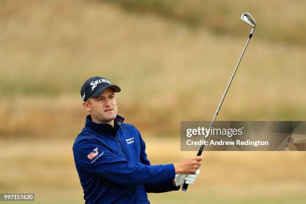 Russell Knox of Scotland takes his second shot on hole eighteen during day one of the Aberdeen Standard Investments Scottish Open at Gullane Golf...
